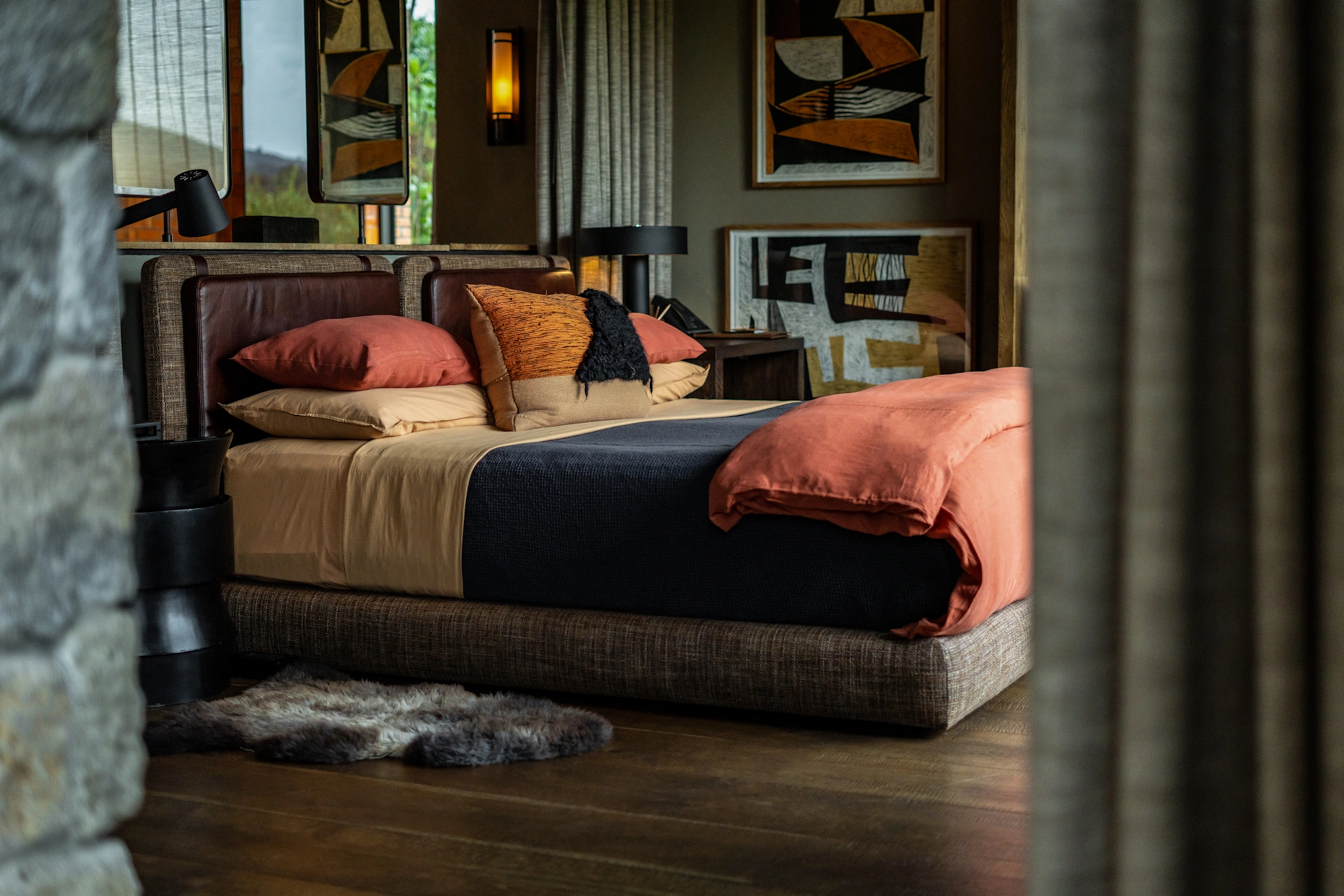 Spacious forest suite interior at Singita Kwitonda featuring handcrafted decor and natural materials