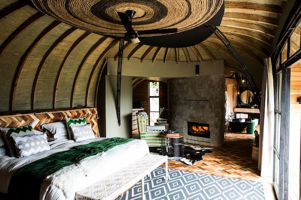 Eco-luxury guest suite at Wilderness Bisate Lodge with panoramic volcanic views