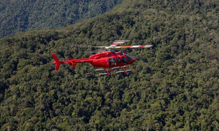 Helicopter Flying Over Forest