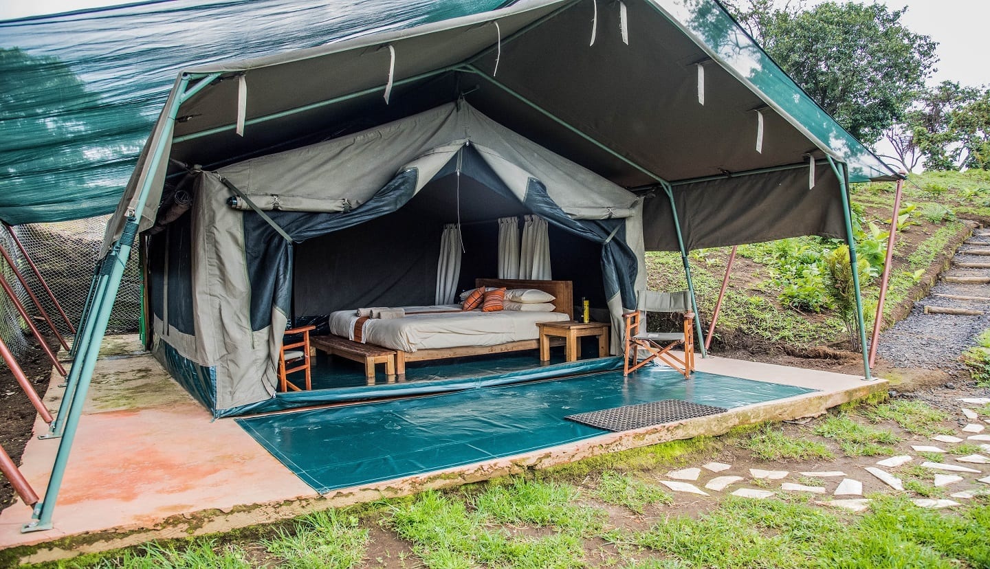 Kibumba Tented Camp provides luxury tented accommodations with breathtaking views of the Virunga Volcanoes and surrounding forests. The camp offers a tranquil atmosphere where travelers enjoy stylish safari tents, campfire evenings, fine dining, and scenic mountain views. Kibumba Tented Camp is especially