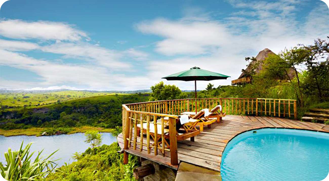 Kyaninga Lodge offers one of Uganda’s most unique luxury lodge experiences overlooking a stunning crater lake near Kibale National Park. Built from handcrafted timber, the lodge combines rustic elegance with modern luxury. Guests enjoy spacious cottages, fine dining, wellness experiences, scenic 